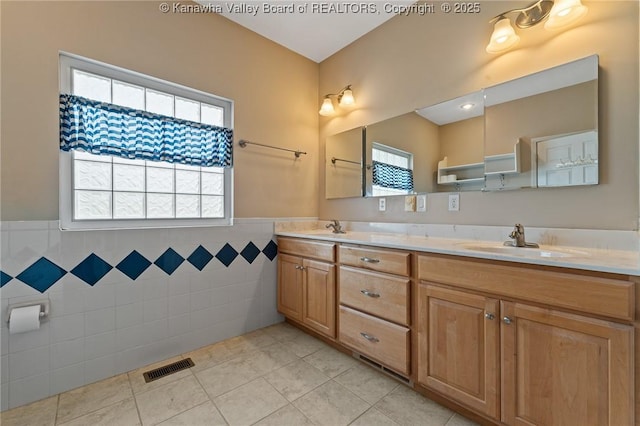 1155 Pike St, Milton, WV 25541 - bathroom with tile walls, tile patterned floors, double vanity, plenty of natural light, and wainscoting