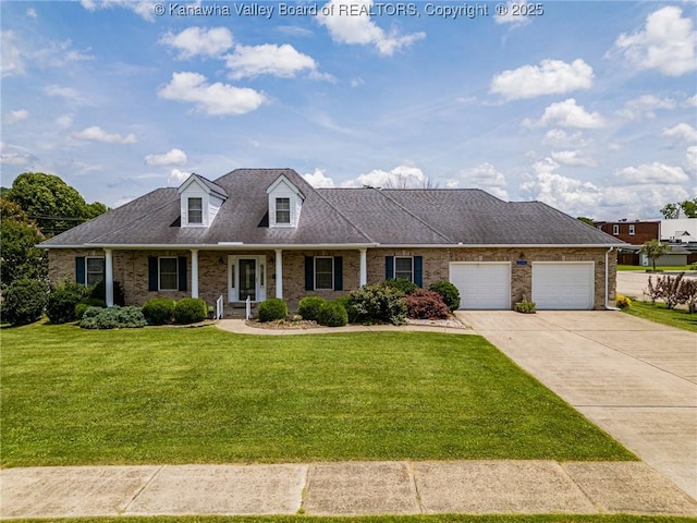 1155 Pike St, Milton, WV 25541 - cape cod home featuring a front lawn, concrete driveway, an attached garage, and brick siding