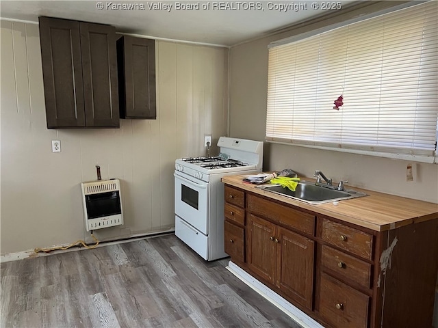 7001/2 Buffington St, Huntington, WV 25702 - kitchen featuring white gas range, heating unit, dark wood-style floors, and butcher block counters