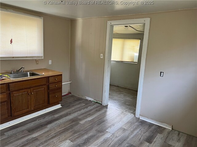 7001/2 Buffington St, Huntington, WV 25702 - kitchen with dark wood-type flooring, light countertops, and brown cabinetry