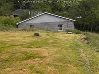 873 Woods Dr, Saint Albans, WV 25177 - view of side of home with a lawn and a forest view