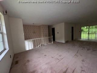873 Woods Dr, Saint Albans, WV 25177 - carpeted empty room featuring plenty of natural light and wallpapered walls