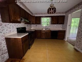 873 Woods Dr, Saint Albans, WV 25177 - kitchen with black appliances, wallpapered walls, dark brown cabinetry, light countertops, and under cabinet range hood