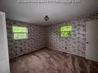 873 Woods Dr, Saint Albans, WV 25177 - carpeted empty room featuring wallpapered walls and baseboards