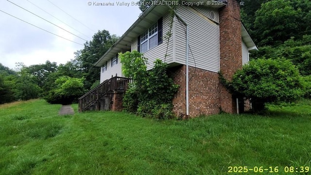 873 Woods Dr, Saint Albans, WV 25177 - view of property exterior featuring brick siding, a chimney, stairway, and a lawn