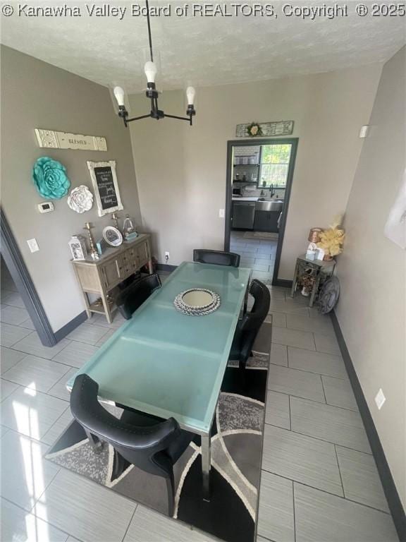 4052 Farmington Dr, Hurricane, WV 25526 - dining area with tile patterned floors, a chandelier, and a textured ceiling