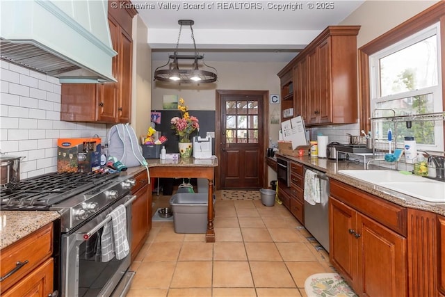 1212 10th St, Huntington, WV 25701 - kitchen with stainless steel appliances, custom exhaust hood, brown cabinetry, and decorative backsplash