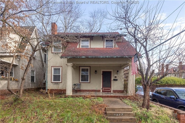 1212 10th St, Huntington, WV 25701 - view of front of property featuring covered porch, stucco siding, and a chimney