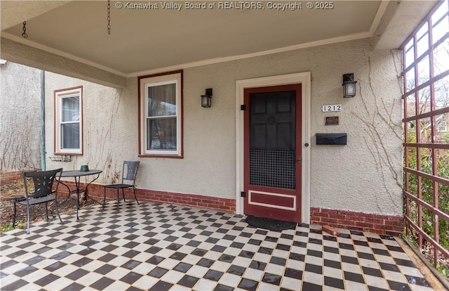 1212 10th St, Huntington, WV 25701 - property entrance featuring brick siding, stucco siding, and outdoor dining space