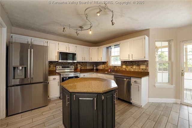 18 Long St, Winfield, WV 25213 - kitchen with stainless steel appliances, wood finish floors, white cabinetry, and decorative backsplash