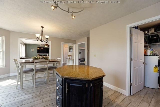 18 Long St, Winfield, WV 25213 - kitchen with electric water heater, wood finish floors, dark cabinets, a chandelier, and a kitchen island