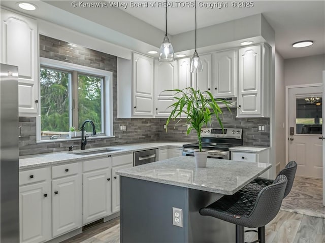 1437 Statts Mills Rd, Ripley, WV 25271 - kitchen featuring stainless steel appliances, white cabinetry, a kitchen bar, and a center island
