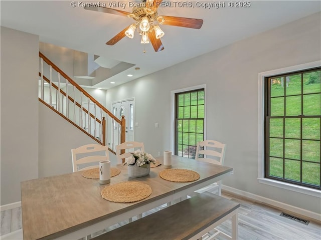 1437 Statts Mills Rd, Ripley, WV 25271 - dining area with healthy amount of natural light, stairway, light wood-style flooring, and ceiling fan