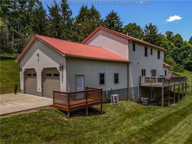 1437 Statts Mills Rd, Ripley, WV 25271 - back of house featuring a wooden deck, a lawn, a metal roof, an attached garage, and concrete driveway