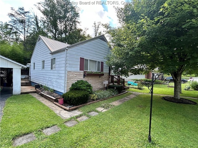 105 Franklin Ave, Saint Albans, WV 25177 - view of property exterior with stone siding, a yard, and a metal roof