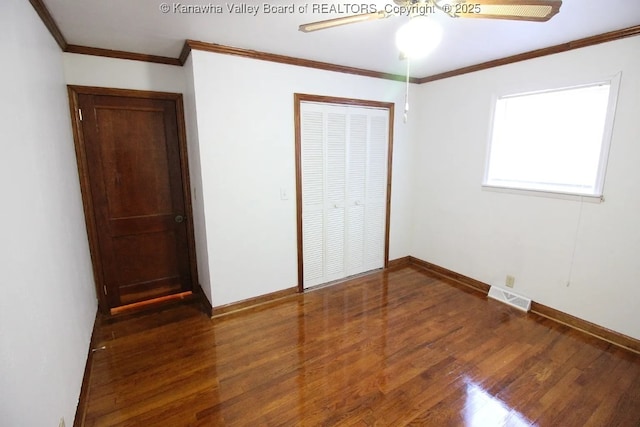 105 Franklin Ave, Saint Albans, WV 25177 - unfurnished bedroom featuring wood finished floors, a closet, crown molding, and a ceiling fan