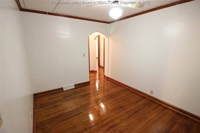 105 Franklin Ave, Saint Albans, WV 25177 - empty room with ornamental molding, arched walkways, a ceiling fan, wood finished floors, and attic access