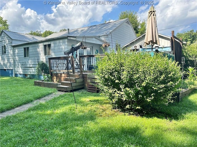 105 Franklin Ave, Saint Albans, WV 25177 - back of property featuring a yard, a deck, and a metal roof