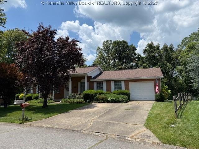 2234 Circle Dr, Milton, WV 25541 - view of front of house featuring a front lawn, concrete driveway, and an attached garage