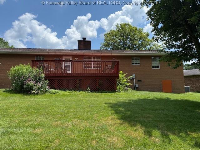 2234 Circle Dr, Milton, WV 25541 - back of property featuring a deck, a yard, a chimney, and brick siding