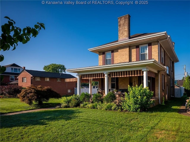 2961 Staunton Rd, Huntington, WV 25702 - back of property featuring a lawn, a chimney, covered porch, and brick siding