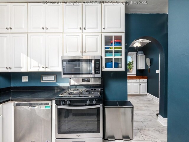 2961 Staunton Rd, Huntington, WV 25702 - kitchen with stainless steel appliances, light marble finish floors, white cabinetry, and dark countertops