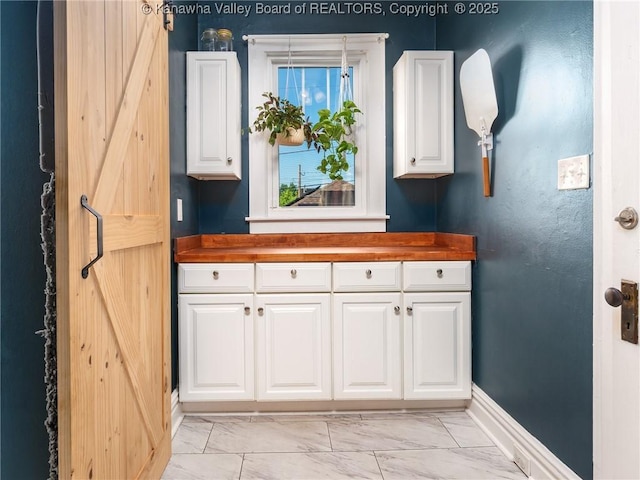 2961 Staunton Rd, Huntington, WV 25702 - kitchen with light marble finish flooring, wood counters, and white cabinets