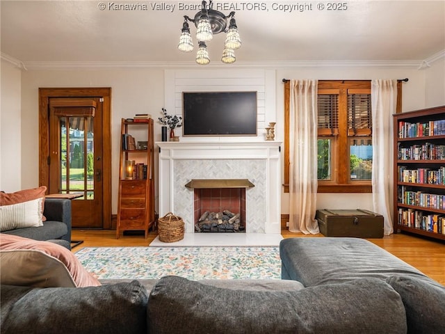 2961 Staunton Rd, Huntington, WV 25702 - living room featuring wood finished floors, crown molding, a tile fireplace, and a chandelier