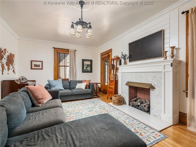 2961 Staunton Rd, Huntington, WV 25702 - living room with ornamental molding, a chandelier, wood finished floors, and a fireplace