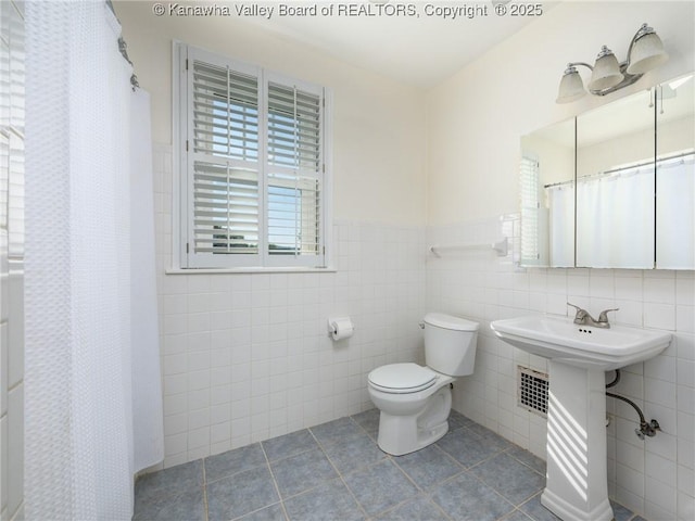 2961 Staunton Rd, Huntington, WV 25702 - full bathroom featuring tile walls, tile patterned floors, a wainscoted wall, and a shower with shower curtain