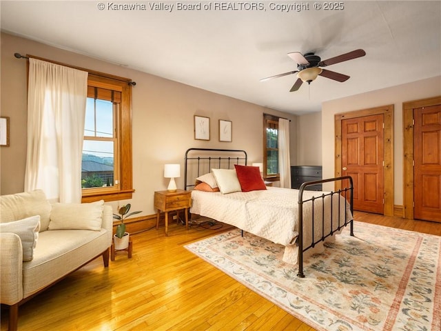 2961 Staunton Rd, Huntington, WV 25702 - bedroom with multiple windows, light wood finished floors, and ceiling fan