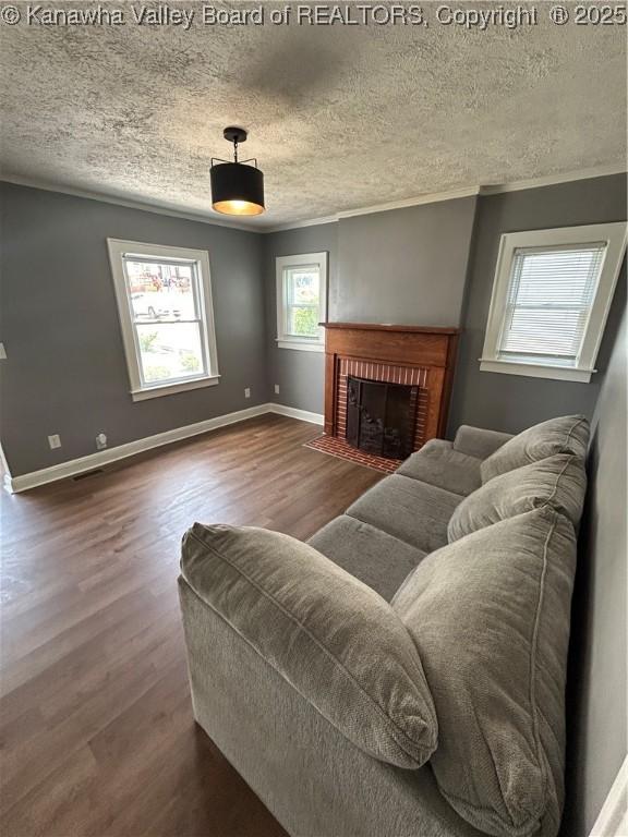 2010 Preston St, Charleston, WV 25302 - living area featuring a textured ceiling, wood finished floors, a fireplace, and ornamental molding