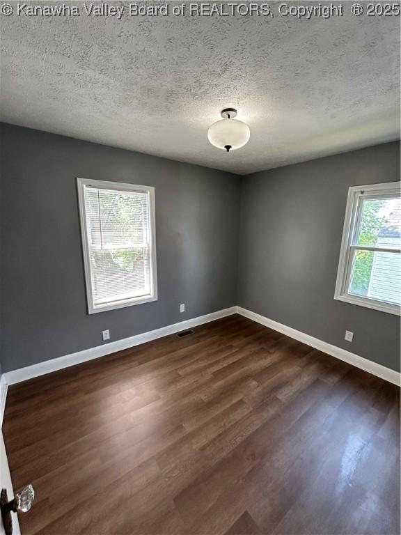 2010 Preston St, Charleston, WV 25302 - unfurnished room with dark wood-type flooring and a textured ceiling