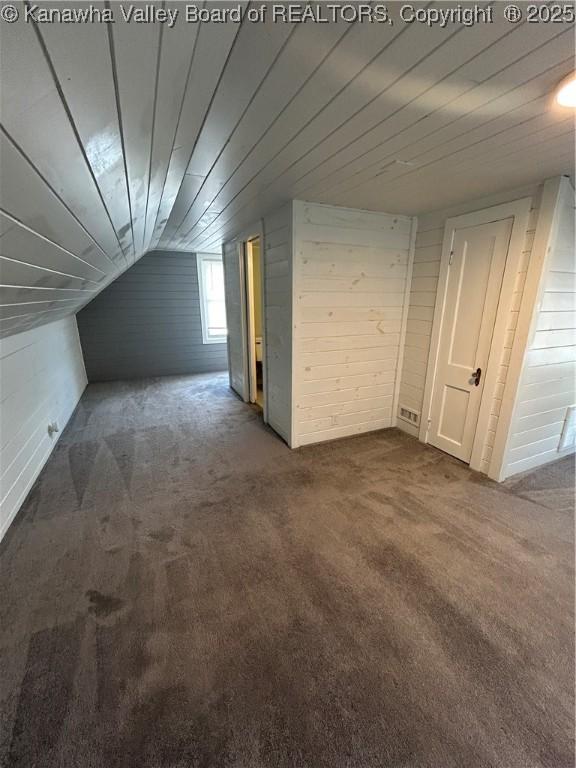 2010 Preston St, Charleston, WV 25302 - bonus room with dark colored carpet, wooden walls, and vaulted ceiling