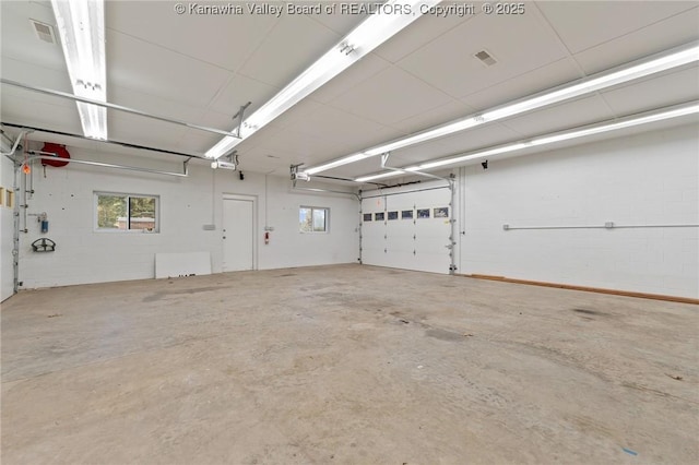 33 Shawnee Oaks Dr, Huntington, WV 25705 - garage with a garage door opener and concrete block wall