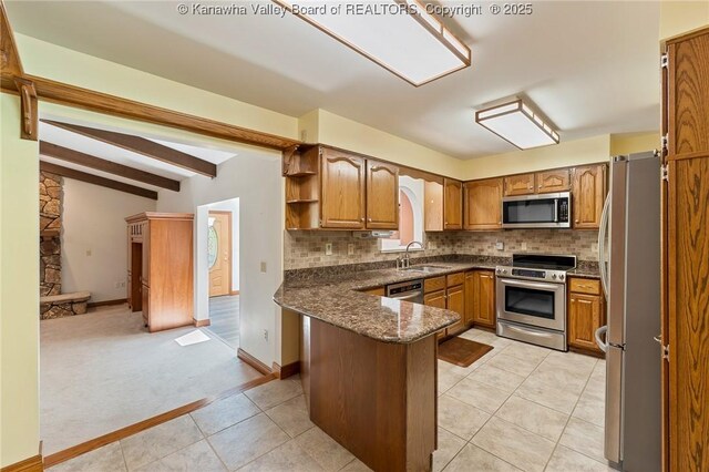 33 Shawnee Oaks Dr, Huntington, WV 25705 - kitchen with appliances with stainless steel finishes, a peninsula, brown cabinetry, tasteful backsplash, and light tile patterned floors