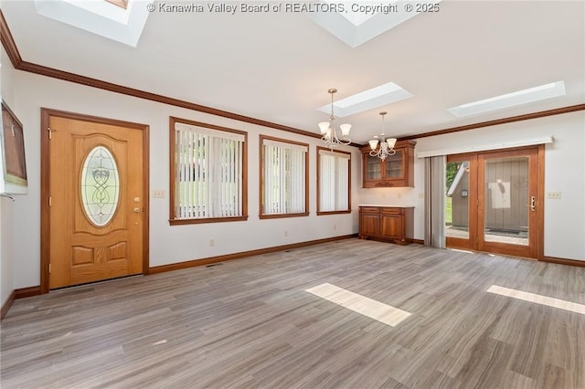 33 Shawnee Oaks Dr, Huntington, WV 25705 - foyer featuring a skylight, a chandelier, light wood finished floors, and ornamental molding