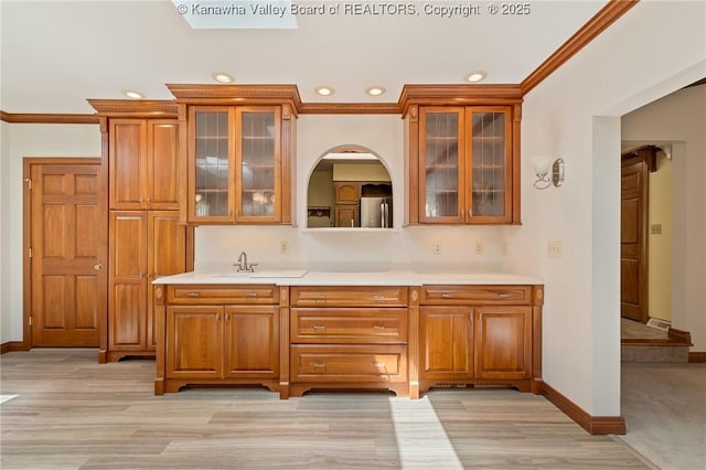 33 Shawnee Oaks Dr, Huntington, WV 25705 - indoor wet bar featuring ornamental molding, recessed lighting, freestanding refrigerator, arched walkways, and light wood-type flooring