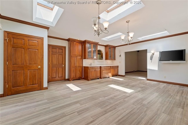 33 Shawnee Oaks Dr, Huntington, WV 25705 - kitchen featuring a skylight, a chandelier, brown cabinetry, decorative light fixtures, and light countertops