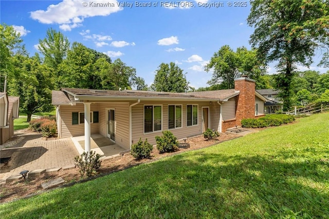 33 Shawnee Oaks Dr, Huntington, WV 25705 - back of house with a patio area, a lawn, and a chimney