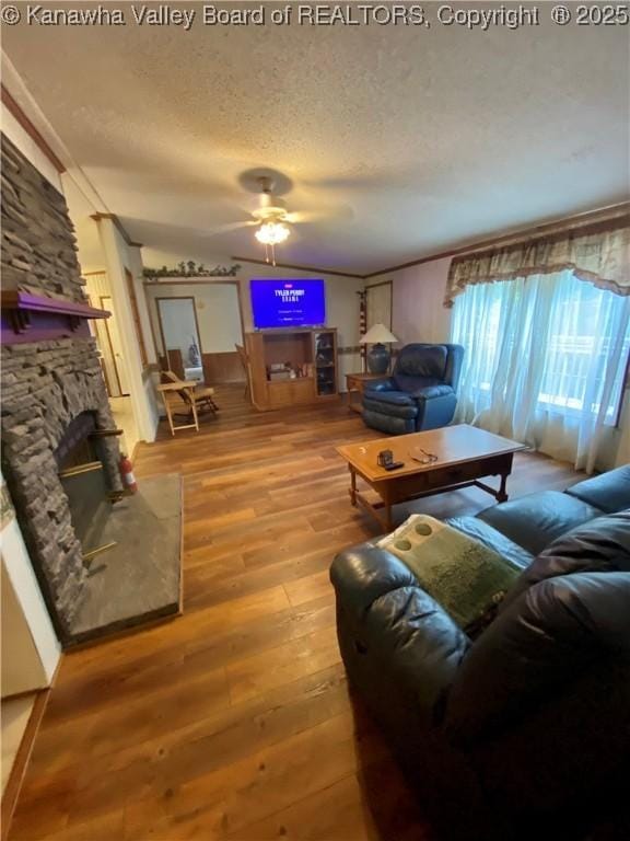 2399 Spicewood Rd, Kenna, WV 25248 - living room featuring hardwood / wood-style flooring, a textured ceiling, a ceiling fan, and a fireplace