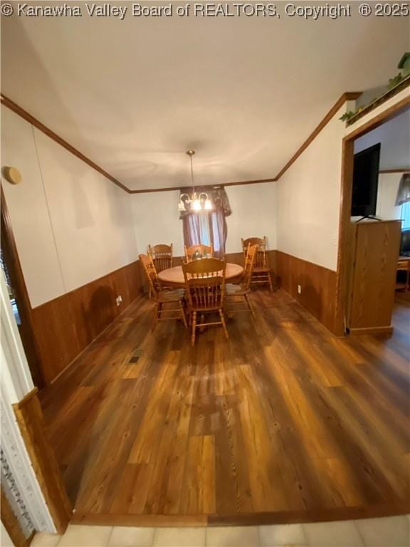 2399 Spicewood Rd, Kenna, WV 25248 - dining space with ornamental molding, a wainscoted wall, wood finished floors, and wooden walls