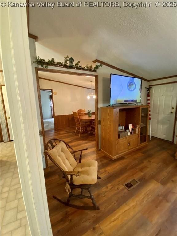 2399 Spicewood Rd, Kenna, WV 25248 - living room with vaulted ceiling, a textured ceiling, and wood finished floors