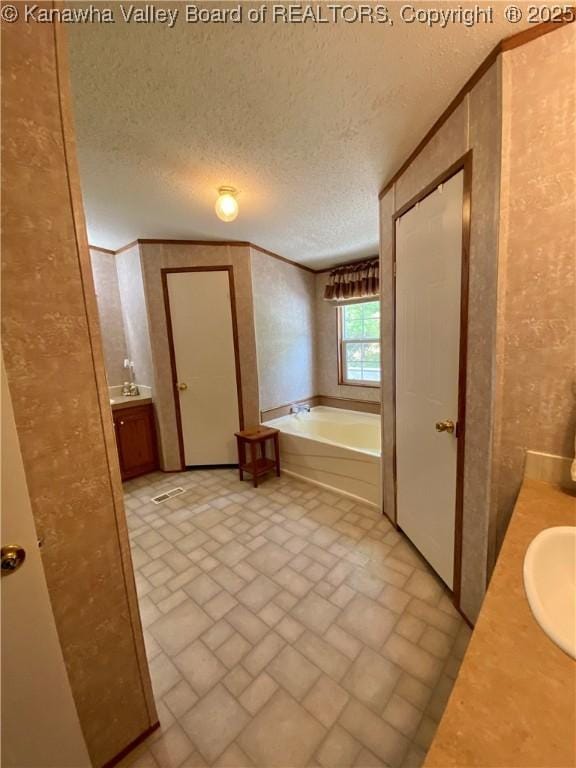 2399 Spicewood Rd, Kenna, WV 25248 - bathroom featuring brick patterned floors, a bath, double vanity, and a textured ceiling