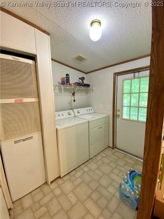 2399 Spicewood Rd, Kenna, WV 25248 - laundry area featuring a heating unit, washing machine and dryer, brick patterned floors, a textured ceiling, and ornamental molding