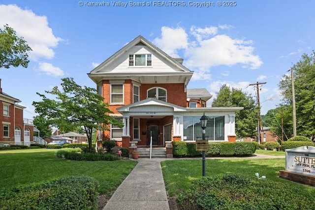 1598 Kanawha Blvd E, Charleston, WV 25311 - view of front of house featuring brick siding, covered porch, and a front yard