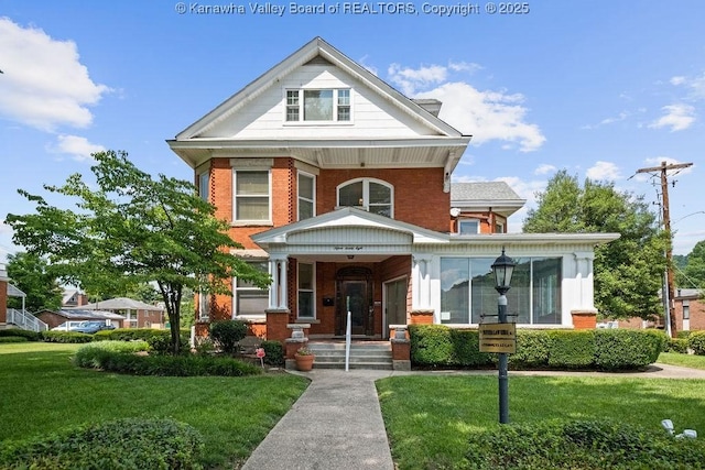1598 Kanawha Blvd E, Charleston, WV 25311 - view of front facade with a porch, brick siding, and a front yard