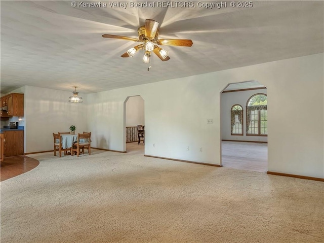 3710 Cambridge Cir, Hurricane, WV 25526 - unfurnished living room featuring arched walkways, light carpet, and a ceiling fan