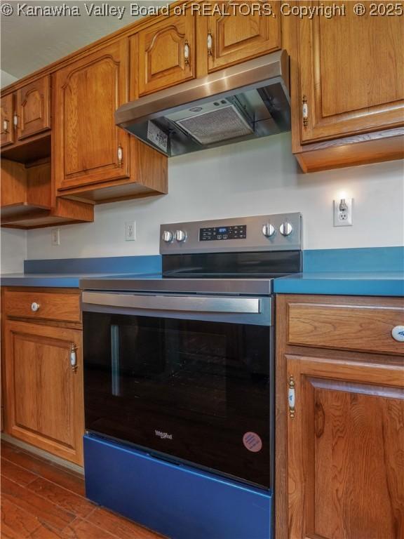 3710 Cambridge Cir, Hurricane, WV 25526 - kitchen with under cabinet range hood, stainless steel range with electric stovetop, and brown cabinetry