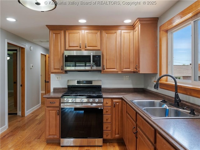 9012 Florida Ave, Marmet, WV 25315 - kitchen featuring stainless steel appliances, light wood-style floors, dark countertops, and recessed lighting